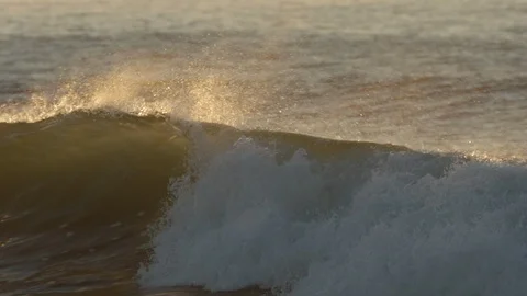 Waves breaking in slow motion at sunset Stock Footage 88288552