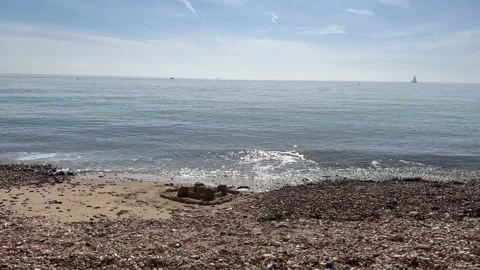 Waves breaking on a stone beach Stock Footage 239656564