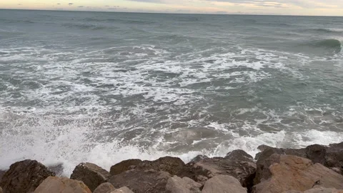 Waves breaking on a stone beach Stock Footage 239656777