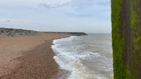 Waves breaking on a stone beach Stock Footage 239657185