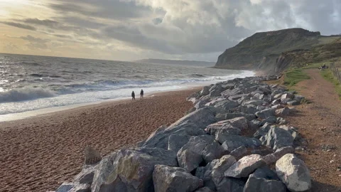 Waves breaking on a stone beach Stock Footage 239657967
