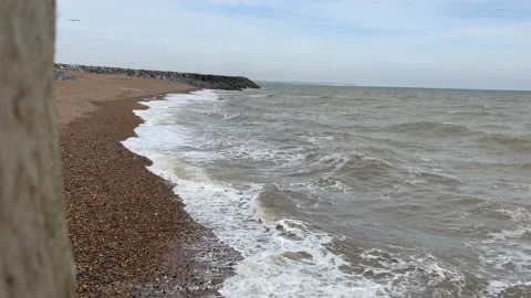 Waves breaking on a stone beach Stock Footage 239658078