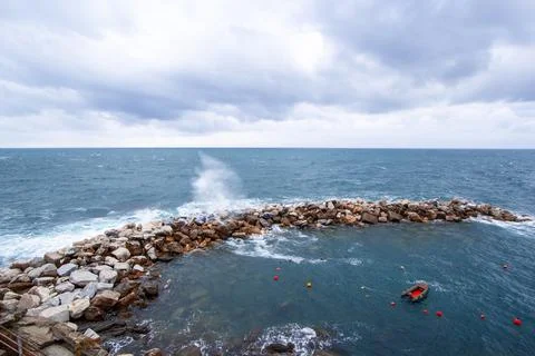 Waves breaking on a stony beach during a thunderstorm Stock Photos