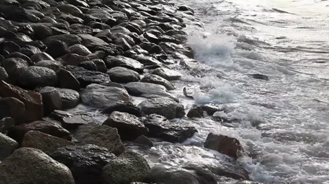 Waves breaking on a stony beach Stock Footage 36218746