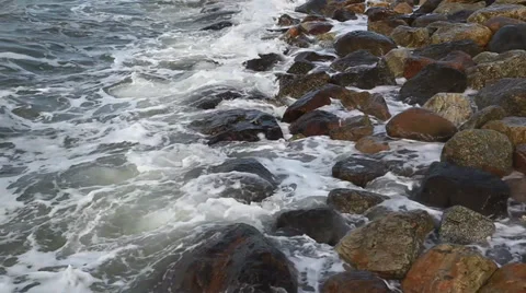 Waves breaking on a stony beach Stock Footage 36218764