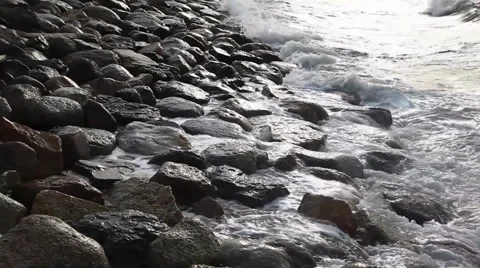 Waves breaking on a stony beach Stock Footage 36220629
