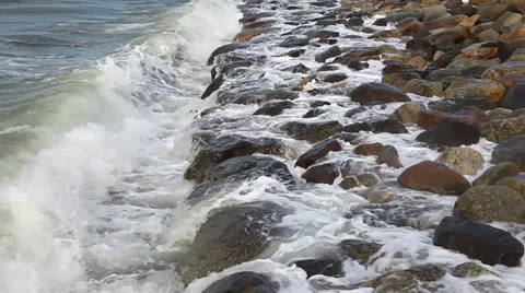 Waves breaking on a stony beach Video stock 36221001
