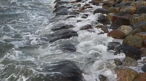 Waves breaking on a stony beach Stock Footage 36221008