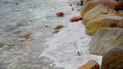Waves breaking on a stony beach Stock Footage 36305953