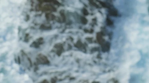 Waves breaking on stony beach Stock Footage 93766854