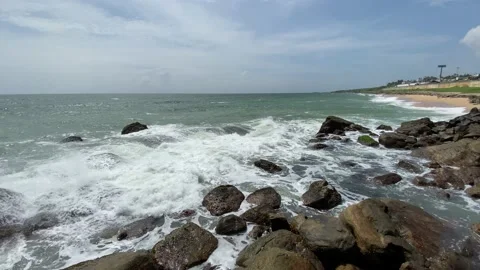 The waves breaking on a stony beach, forming a spray Stock Footage 164873012