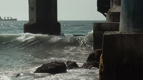 Waves breaking in structure of a pier Stock Footage 137064749