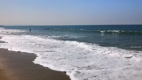 Waves Breaking Surfers in Distance Stock Footage 95768991