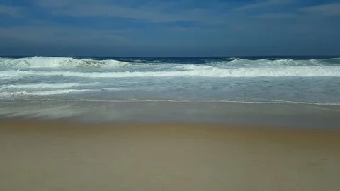 Waves breaking, white foam, blue sky and sea, in Itacoatiara beach, Brazil. Stock Footage 119394846