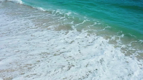 Waves breaking on a white sand beach Stock Footage 147907311