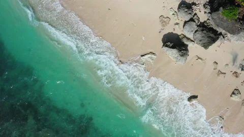 Waves breaking on a white sand beach Stock Footage 148057578