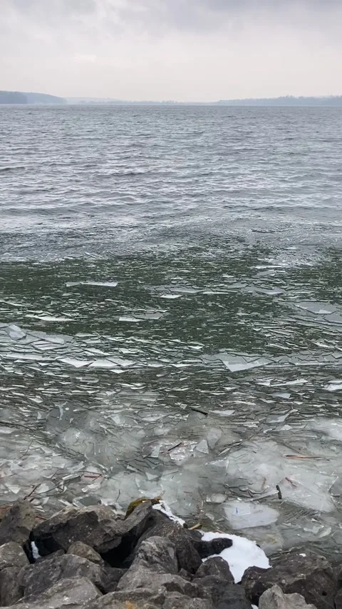 Waves with broken ice on lake Stock Footage 274364242
