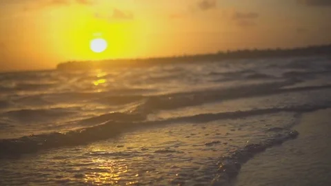 Waves in the calm on the ocean in the sunset gently caress the shore Stock Footage 72152083