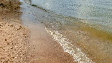 Waves calmly roll to the shore, small ripples, close-up shot Stock Footage 82918863