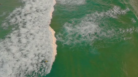 Waves carrying a surfboard towards the beach on Maroubra, Sydney, Australia, 4K 動画素材 105087607