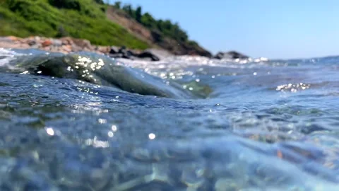 Waves churn violently above as bubbles accelerate through the water, pulled by Stock Footage 313486005