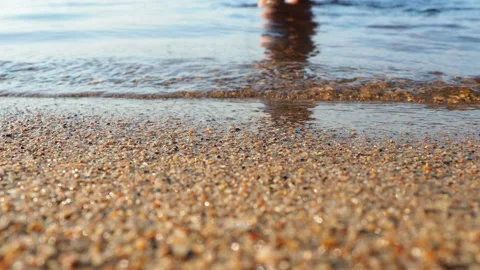 Waves of clear water crash on sandy beach. Golden hour, sunset. Rest on the Stock Footage 231585974