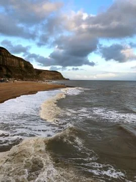Waves, Cliffs, Sunset on the Hastings beach, England Stock Photos