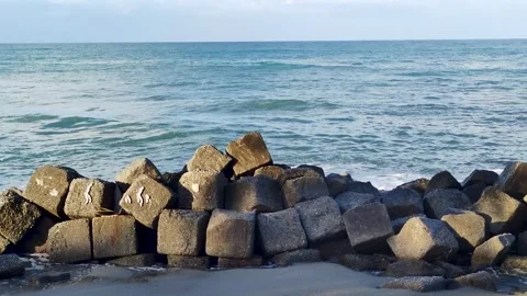 Waves Collides with Large Rocks Breaking on the Edge of Rocks  Stock Footage 252996399