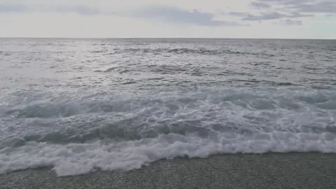 Waves come and go on a pebbled beach Stock Footage 280771377