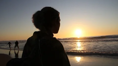 Waves come right up to girl Stock Footage 123200580