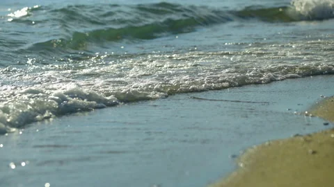 Waves coming onto the beach sand Stockbeeldmateriaal 212748116