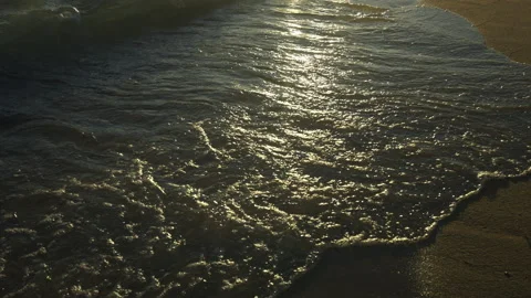 Waves coming onto the beach sand Stockbeeldmateriaal 212956960