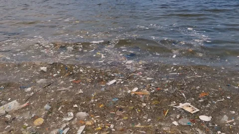 Waves coming with junk. A lot of garbage in the sea. Stock Footage 120089841