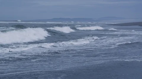 Waves coming into the shore on a cold and gloomy day Stock Footage 81344487