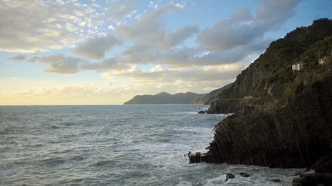Waves crash against cliffs at sunset in the Cinque Terre of Italy Video stock 103283661
