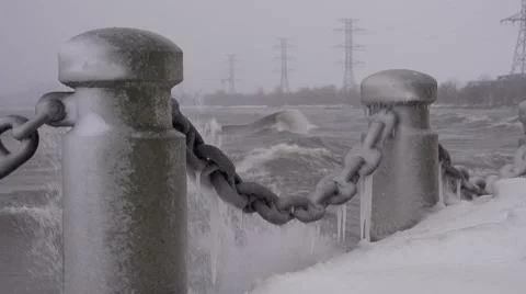 Waves crash against froven posts 動画素材 46227532