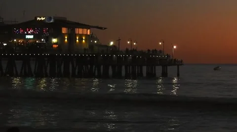 Waves Crash Against an Ocean Pier at Dusk Stock Footage 62493439
