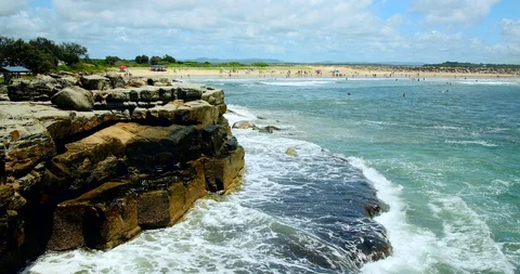 Waves crash against rocks on beach in australia Stock Footage 128702178