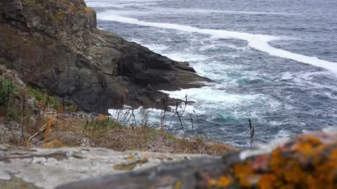 Waves crash against the rocks on the cliff Stock Footage 157606876