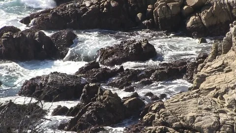 Waves crash against rocks Stock Footage 77011343