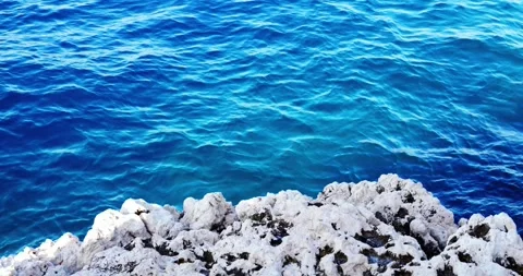 Waves crash against the rocks in the Gulf of Naple Stock Footage 315698879