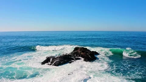 Waves crash against rocks in the middle of the ocean. Stock Footage 170525237