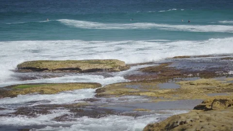 Waves crash against the rocks at a section at Bondi Beach, in slow motion Stock Footage 86789606