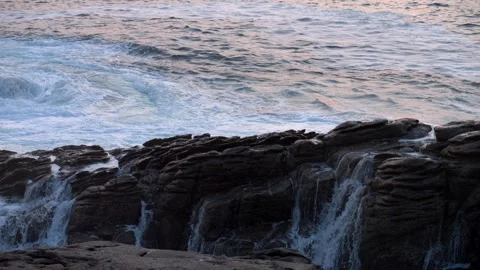 Waves crash against rocks at sunset. Rough sea. Slow motion 4K 스톡 동영상 288013901