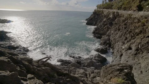 Waves crash against rocky cliffs in Manarola in Cinque Terre Video stock 103307458