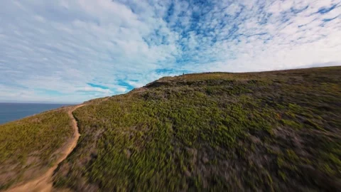 Waves crash against rugged cliffs under a dynamic sky Stock Footage 340905253