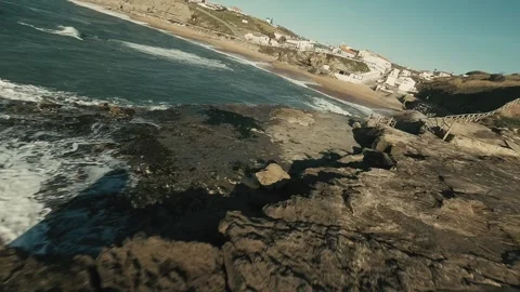 Waves crash against rugged rocks below Stock Footage 341826155