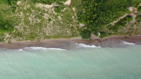 Waves crash ashore beach on Lake Huron descending from above Stock Footage 125039155