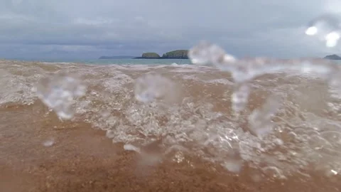 Waves crash onto beach at Ballintoy Northern Ireland Vídeos de archivo 316970153