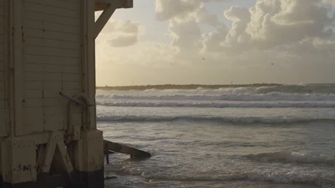 Waves crash on beach - lifeguard tower in foreground Stock Footage 100708127
